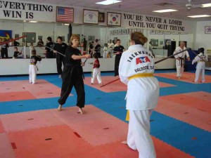 World Champion Jennifer Powell and the other Instructors, each help individual leadership students with their bo-staff techniques.